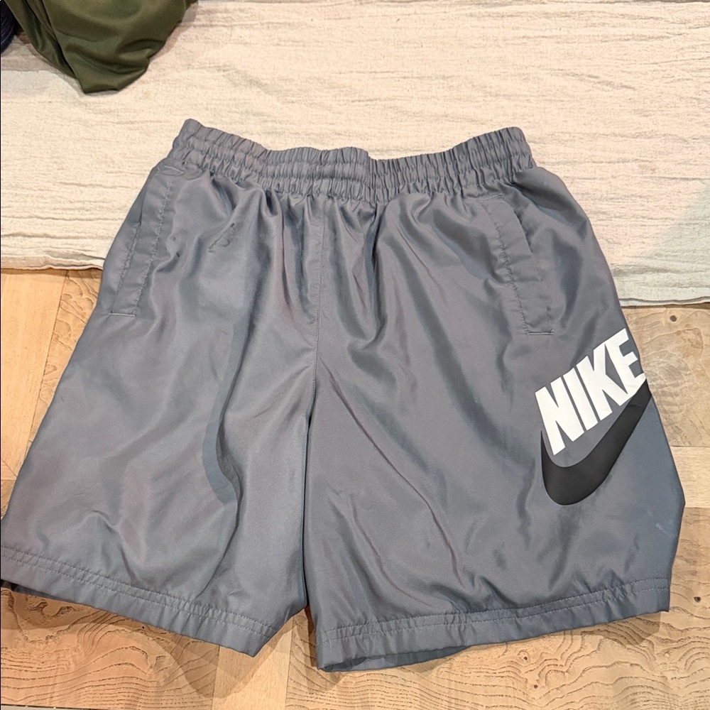 Nike Gray Athletic Shorts with White Logo and Black Swoosh